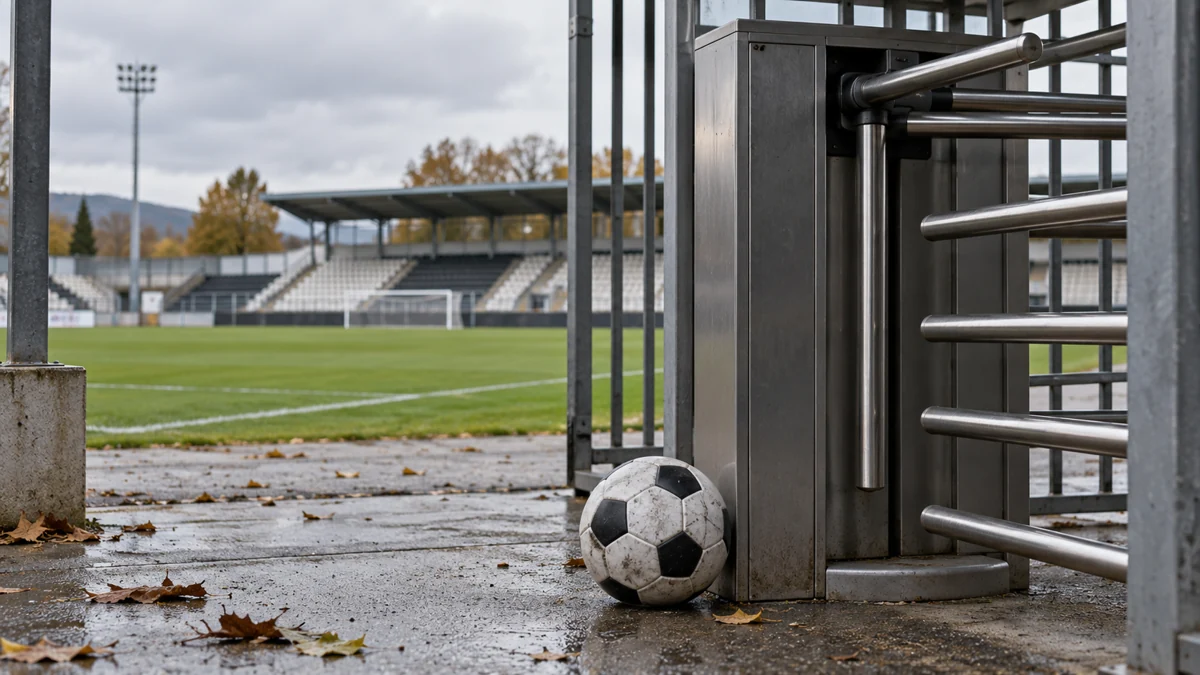 Football beside the entrance turnstile of an empty stadium